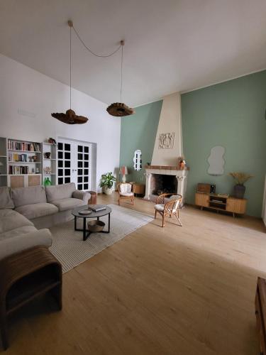 a living room with a couch and a fireplace at Casa Ianca in Lecce