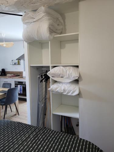 a room with a bed and some pillows on shelves at Un Bibou de Campagne 1 in Le Theil-de-Bretagne