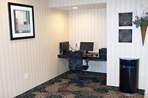 a room with a desk with a computer and a chair at Cobblestone Inn & Suites - Langdon in Langdon
