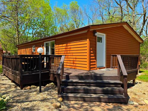 a small cabin with two benches in front of it at Put-in-Bay Island Club #97 in Put-in-Bay