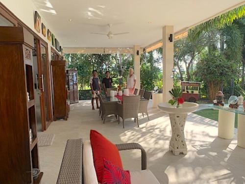 a living room with a couch and a table at Wake up to the Sea of Bali Beachfront luxury plus in Singaraja