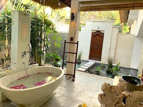 a large bath tub in a room with at Wake up to the Sea of Bali Beachfront luxury plus in Singaraja