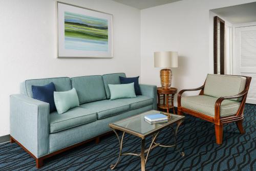 a living room with a couch and a chair at Coco Key Hotel & Water Park Resort in Orlando