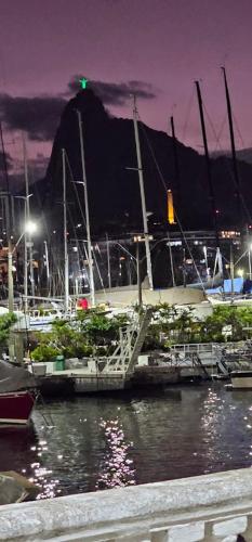 a group of boats docked in a harbor at night at Luxo na Gloria in Rio de Janeiro