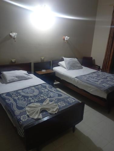 Ένα ή περισσότερα κρεβάτια σε δωμάτιο στο Scarabee hotel