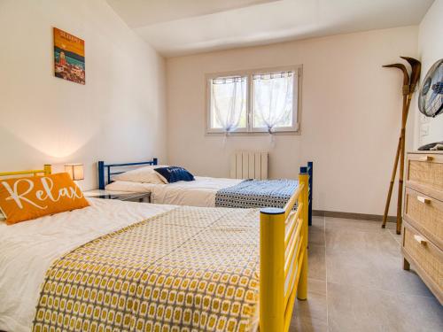 a bedroom with two beds and a window at Holiday Home Villa Azurine by Interhome in Garéoult
