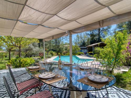 a patio with a table and chairs and a pool at Holiday Home Villa Azurine by Interhome in Garéoult