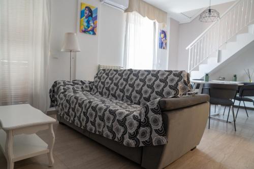a living room with a couch and a table at Stabiae Suite Sorrento Coast Suites in Castellammare di Stabia