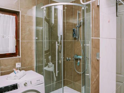 a bathroom with a shower with a glass door at Holiday Home IV-AN by Interhome in Perušić