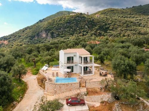 an aerial view of a house with a mountain at elli epavlis private pool starlink wifi near barbati in Spartýlas
