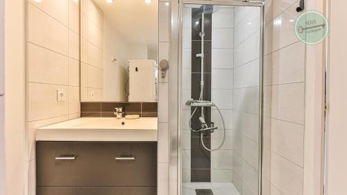une salle de bain avec un lavabo et une douche dans l'établissement Residence les Oyats, à Les Bussolleries