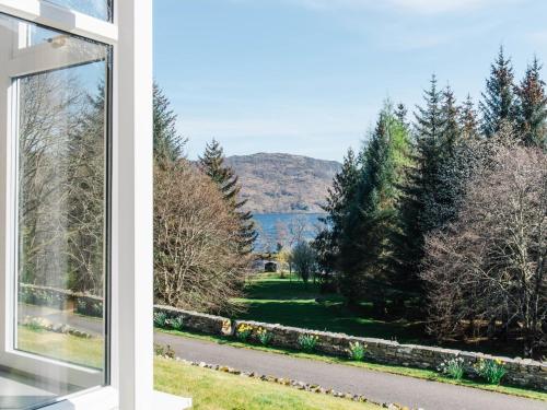 a window of a house with a view of a yard at Holiday Home Farmburn Bothy by Interhome in Invermoriston