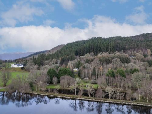a view of a river with trees and a mountain at Holiday Home Farmburn Bothy by Interhome in Invermoriston
