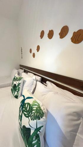 a bedroom with a bed with cookies on the wall at Pousada Oceano Atlântico in Marau