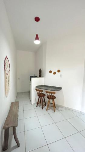 a dining room with a table and a bench at Pousada Oceano Atlântico in Marau
