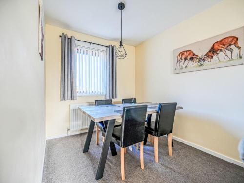 a dining room with a table and chairs at Holiday Home Appletree by Interhome in Muir of Ord