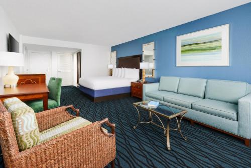 a hotel room with a couch and a bed at Coco Key Hotel & Water Park Resort in Orlando