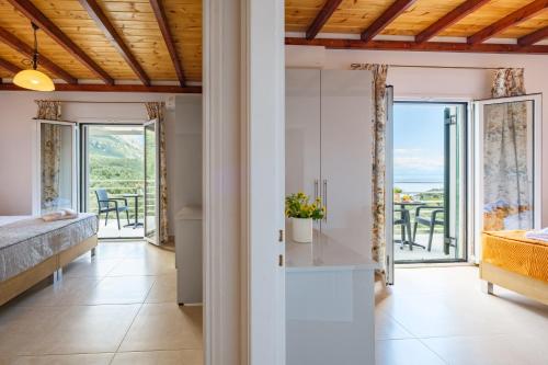 a bedroom with a bed and a view of the ocean at elli epavlis private pool starlink wifi near barbati in Spartýlas