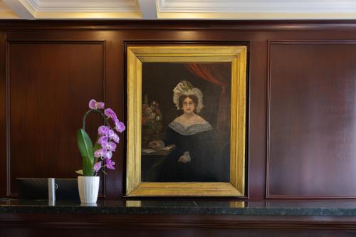 a painting of a woman with a tiara on a wall at The Marshall House, Historic Inns of Savannah Collection in Savannah