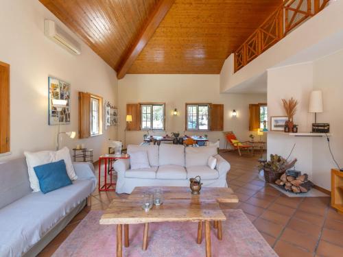 a living room with white couches and a wooden ceiling at Holiday Home Refúgio no Montalvo by Interhome in Alcácer do Sal