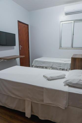 Postel nebo postele na pokoji v ubytování Pousada das Maracanãs
