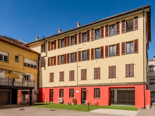 an apartment building with red and white at Apartment Piazza San Giuseppe-10 by Interhome in Acquaseria