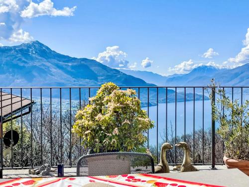 a table and chairs with a view of the mountains at Apartment Buongusto by Interhome in Bugiallo