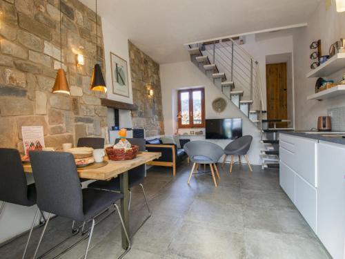 a kitchen and dining room with a table and chairs at Holiday Home Kira by Interhome in Molazzana