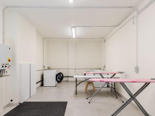 a room with two tables and a refrigerator at Apartment Piazza San Giuseppe-4 by Interhome in Acquaseria