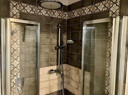 a shower with a glass door in a bathroom at Agriturismo Santa Maria in Pienza