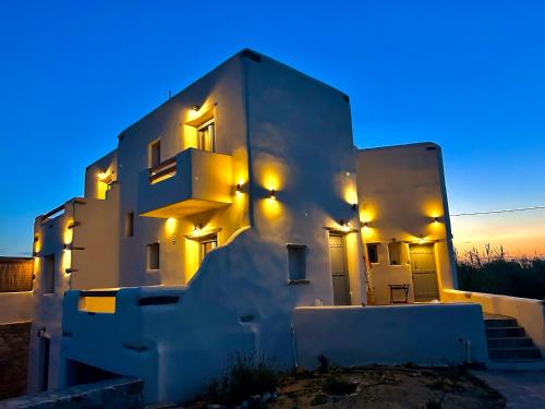 a white building with lights on the side of it at Hidden Eden Residences - Private Pools in Plaka