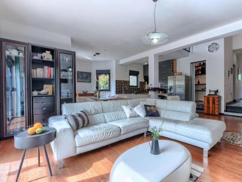 a living room with a white couch and a kitchen at Holiday Home Acquila by Interhome in Umag