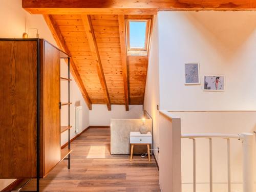 an attic hallway with wooden ceilings and a window at Apartment Piazza San Giuseppe-7 by Interhome in Acquaseria