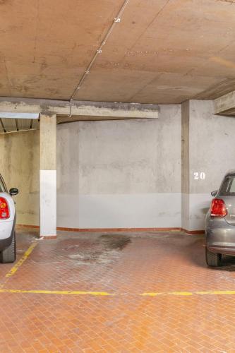 a parking garage with two cars parked in it at La Piccola Luxury Suite in Rome