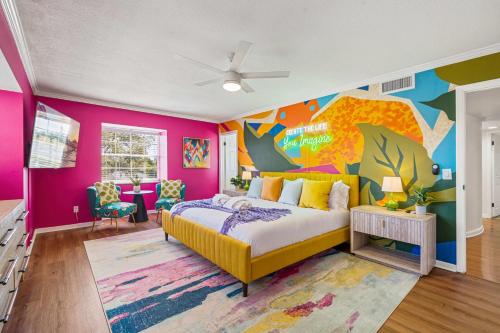 a bedroom with a bed and a colorful wall at Heated Pool Pickleball Mini Golf — Sleeps 20 in Clearwater