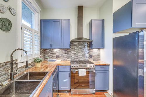 a kitchen with blue cabinets and a sink at 1 Mi to Dtwn Welcoming Macon Home with Yard in Macon