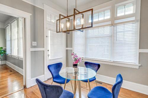 a dining room with blue chairs and a glass table at 1 Mi to Dtwn Welcoming Macon Home with Yard in Macon