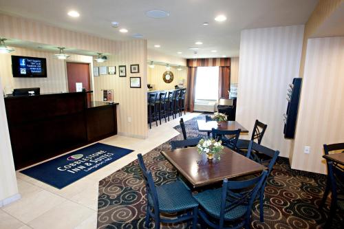 a restaurant with a table and chairs and a bar at Cobblestone Inn & Suites - Langdon in Langdon