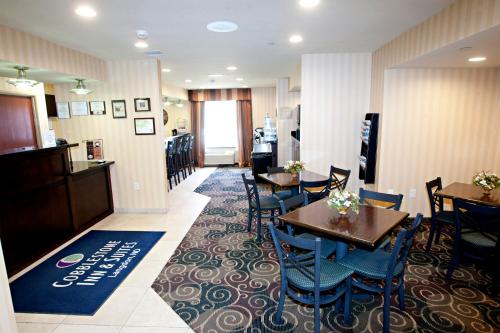 a restaurant with tables and chairs and a bar at Cobblestone Inn & Suites - Langdon in Langdon