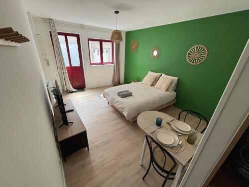 a small room with a bed and a table at Le Studio du Marechal in Niort