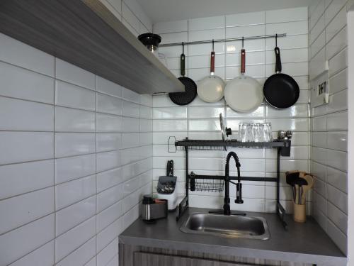 a kitchen with a sink and some pots and pans at Casa Martina Manga Cartagena in Cartagena de Indias