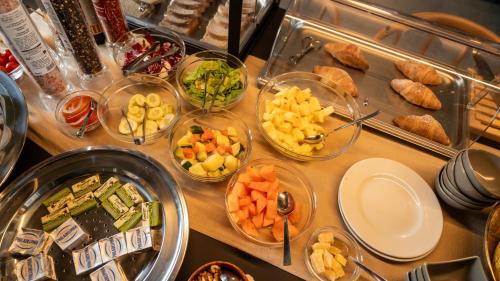a table topped with bowls of different types of food at Terreforti Luxury Village in Agrigento