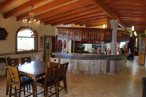 a kitchen and dining room with a table and a bar at Encantó del Mar - Beachfront house in Tijuana