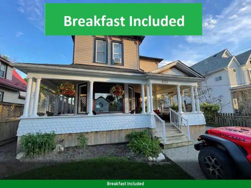 a house with a front porch with the words breakfast included at Perfection near the River - 4 Bedroom Villa Complimentary Breakfast Delivered Daily to the Rental in Niagara Falls