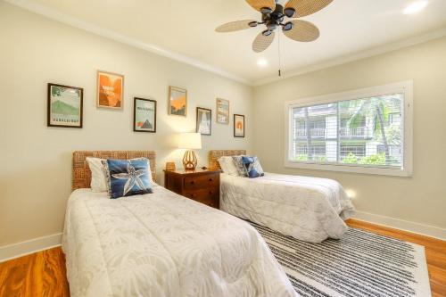 a bedroom with two beds and a window at Walk to Poipu Beaches Koloa Condo with Pool Access! in Koloa
