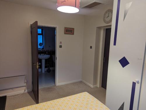 a room with a door and a clock on the wall at The Gabriels in Shaw