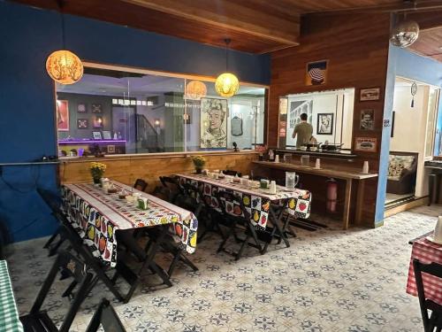 a dining room with two tables in a restaurant at Ipanema Club Hostel in Rio de Janeiro