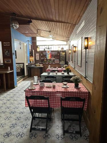 a table with chairs and a red and white checkered table cloth at Ipanema Club Hostel in Rio de Janeiro