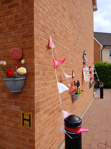 a brick wall with pink and white flags on it at Marina & Seagulls in East Cowes