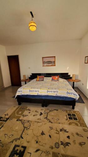 a bedroom with a bed in a room with a rug at El Monasterio in San Joaquín